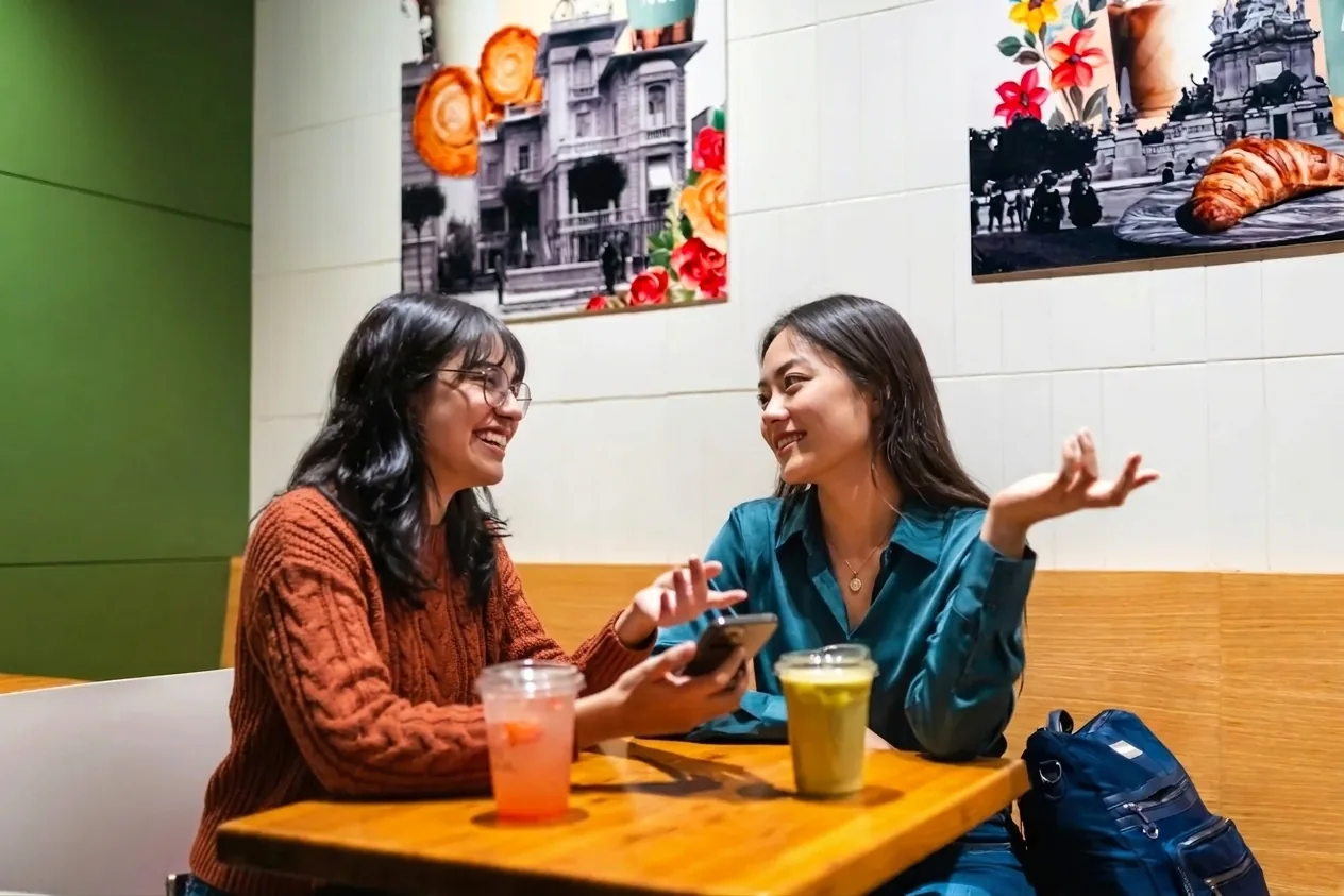 Two friends sharing a conversation at a café